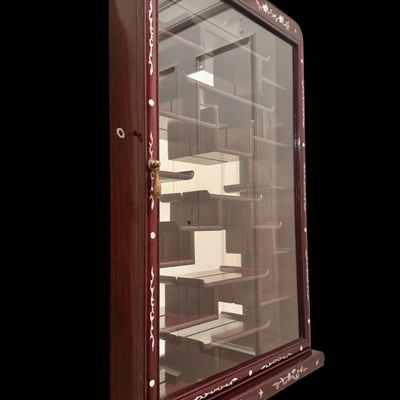 Sale Photo Thumbnail #191: Exquisite wall-mounted curio cabinet, often referred to as a “bogu” shelf constructed from dense rosewood and features intricate beautiful mother-of-pearl inlay. The frame is adorned with delicate floral and avian motifs and enclosed by a glass-fronte