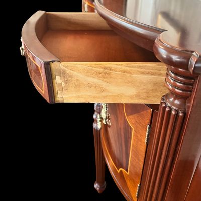 Sale Photo Thumbnail #90: Elegant and high quality Kindel Furniture sideboard executed in the Federal Style with refined neoclassical elements. It features a bow front design, characteristic of the period with flame mahogany veneers, and contrasting stringing inlay. The piece is s