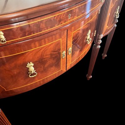 Sale Photo Thumbnail #83: Elegant and high quality Kindel Furniture sideboard executed in the Federal Style with refined neoclassical elements. It features a bow front design, characteristic of the period with flame mahogany veneers, and contrasting stringing inlay. The piece is s