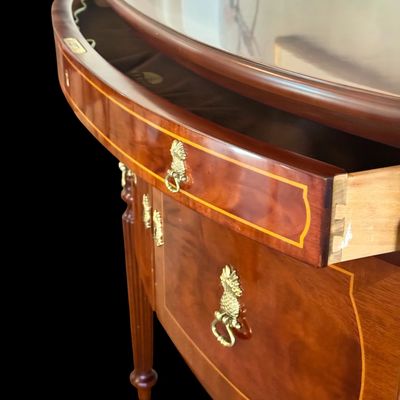 Sale Photo Thumbnail #86: Elegant and high quality Kindel Furniture sideboard executed in the Federal Style with refined neoclassical elements. It features a bow front design, characteristic of the period with flame mahogany veneers, and contrasting stringing inlay. The piece is s