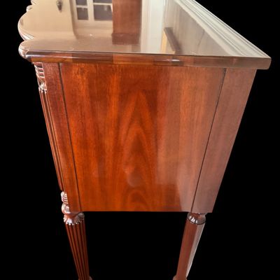 Sale Photo Thumbnail #95: Elegant and high quality Kindel Furniture sideboard executed in the Federal Style with refined neoclassical elements. It features a bow front design, characteristic of the period with flame mahogany veneers, and contrasting stringing inlay. The piece is s