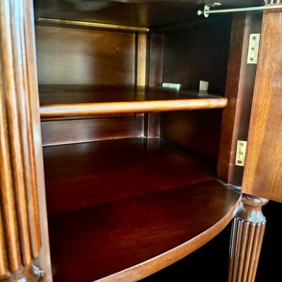 Sale Photo Thumbnail #92: Elegant and high quality Kindel Furniture sideboard executed in the Federal Style with refined neoclassical elements. It features a bow front design, characteristic of the period with flame mahogany veneers, and contrasting stringing inlay. The piece is s