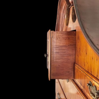 Sale Photo Thumbnail #108: This exquisite Queen Anne style highboy features a classic bonnet-top (or swan's neck) pediment adorned with a central carved shell motif and finials. The piece is constructed with rich, figured walnut veneers, showcasing intricate grain patterns across t