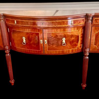 Sale Photo Thumbnail #81: Elegant and high quality Kindel Furniture sideboard executed in the Federal Style with refined neoclassical elements. It features a bow front design, characteristic of the period with flame mahogany veneers, and contrasting stringing inlay. The piece is s