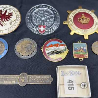 Sale Photo Thumbnail #26: Collection of vintage European car grille badges and enamel medallions, including items from the Royal Automobile Club Belgique and Touring Club Suisse.