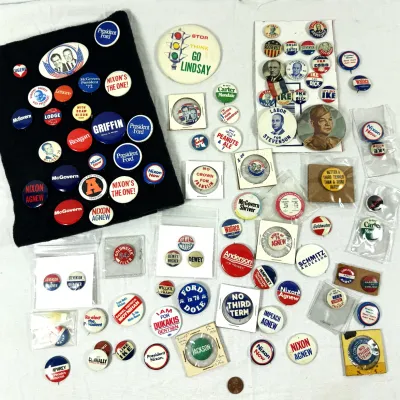 Sale Photo Thumbnail #13: Large collection of vintage political campaign buttons and pins spanning various presidential elections from the 20th century.