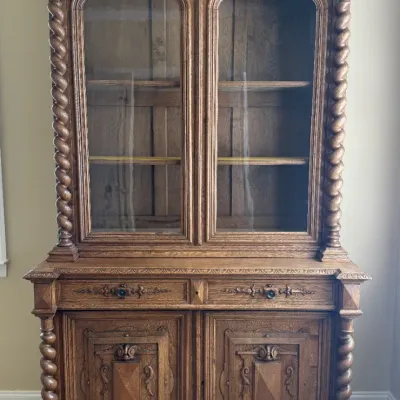 Sale Photo Thumbnail #19: Antique French Renaissance Revival carved oak hutch with barley twist columns, glass-front upper cabinet, and carved lower door panels.