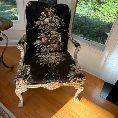 Sale Photo Thumbnail #5: French Provincial style accent armchair with a distressed off-white carved wooden frame and dark floral tapestry upholstery, including a matching lumbar pillow.