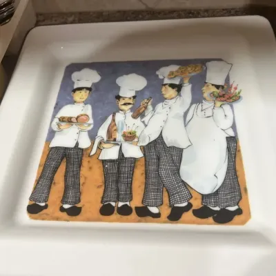 Square ceramic serving platter featuring an illustration of four chefs carrying food and wine.