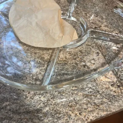 Vintage clear pressed glass divided relish tray or chip-and-dip platter, featuring a central dip bowl section and surrounding compartments.