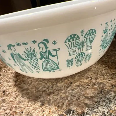 Vintage Pyrex Butterprint pattern white milk glass mixing bowl featuring teal farm scenes.