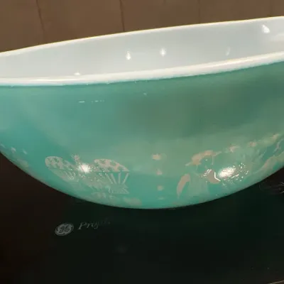 Vintage Pyrex turquoise Cinderella mixing bowl featuring the Butterprint farm motif, circa 1950s-1960s.