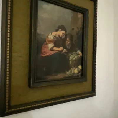 Framed reproduction print of Bartolomé Esteban Murillo's "The Little Fruit Seller" in a dark wooden frame with a fabric mat.