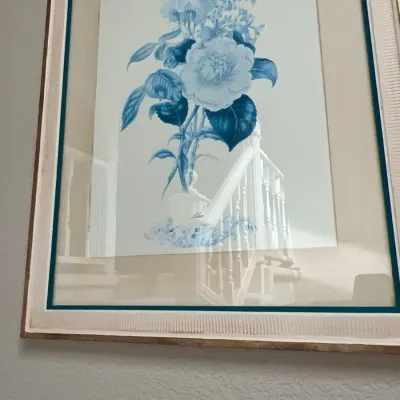 Framed botanical art print depicting blue and white flowers, double-matted under glass in a textured wooden frame.