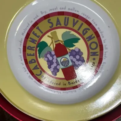 Round appitizer plate set featuring a Cabernet Sauvignon wine-themed central graphic with a bottle and grape clusters.