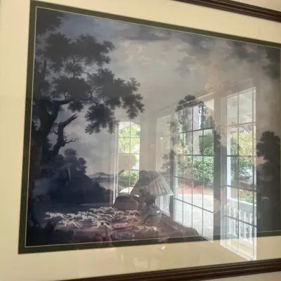 Large framed landscape art print in a dark wood frame with double matting, depicting a classical pastoral scene with trees.