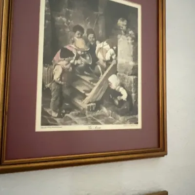 Framed black and white art print depicting children playing, housed in a double-matted gilt wood frame.
