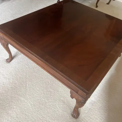 Traditional square mahogany coffee table featuring cabriole legs with ball-and-claw feet and a polished finish.