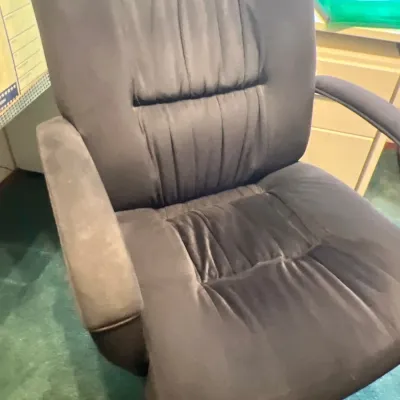 High-back plush swivel office chair upholstered in dark gray microfiber fabric, featuring padded armrests and a five-star caster base.