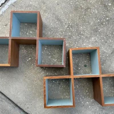Pair of mid-century modern style wooden wall-mounting shadow box shelves with light blue painted interiors.