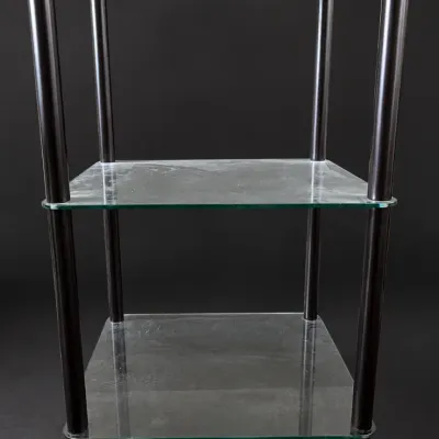 Contemporary three-tier glass and dark metal shelf unit, suitable for media or display.