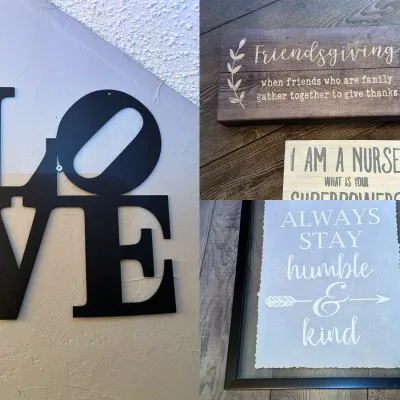 Collection of modern wall art signs, including a black metal LOVE silhouette sign and three framed wooden and glass inspirational quote...