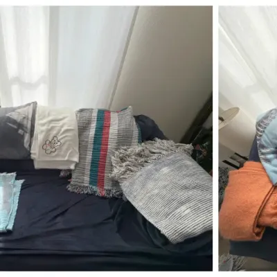 Collection of assorted throw blankets and towels in various patterns, colors, and textures, arranged on a sofa.