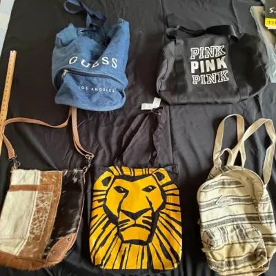 Collection of five assorted bags including a Guess denim drawstring backpack, Victoria's Secret Pink duffel, hair-on-hide shoulder...