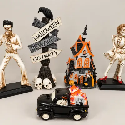 Collection of pop culture Halloween decorations, featuring skeleton figures inspired by Elvis Presley and Marilyn Monroe, a haunted house...