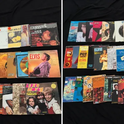 Large collection of vintage vinyl record albums and sheet music, featuring numerous Elvis Presley titles along with classic rock and pop...