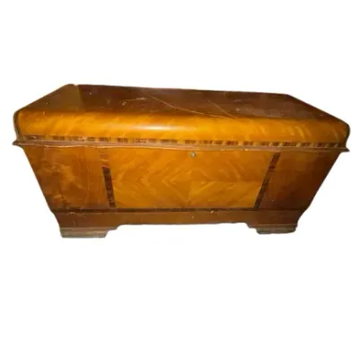 Vintage Art Deco style cedar trunk featuring bookmatched wood veneer and a rounded waterfall lid.