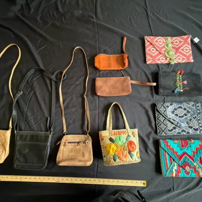 Collection of assorted women's handbags and clutches, including leather crossbody bags, a woven Bahamas straw tote, and beaded...