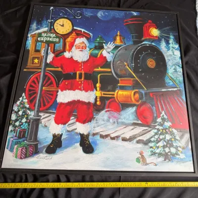 Framed Susan Comish Christmas canvas print featuring Santa Claus standing in front of a train labeled 'Santa Express'.