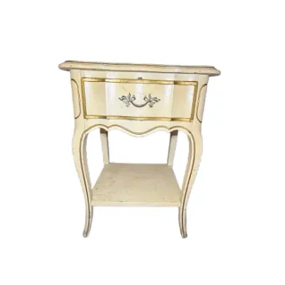 French Provincial style cream-painted nightstand with gold trim highlights, a single upper drawer, and cabriole legs.