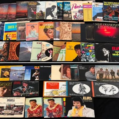 Large collection of vintage vinyl LP records featuring artists such as Elvis Presley, The Doors, Neil Diamond, and Doris Day.