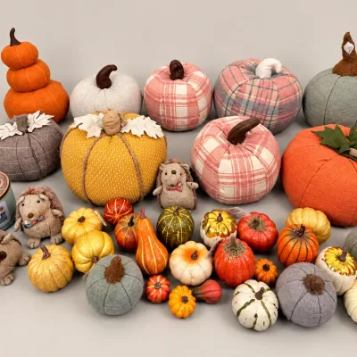 Collection of autumn themed decor featuring fabric and faux mini pumpkins, gourds, plush hedgehogs, and a pumpkin-scented candle.