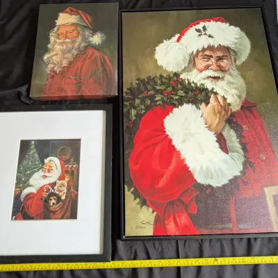 Set of three Santa Claus art prints in varying sizes, including two framed portraits and one unframed canvas.