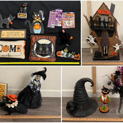 Collection of Halloween decorations including a haunted house table piece, witch figurine, decorative pillows, black cat statues, and...