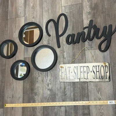 Collection of modern home decor including four round black-framed mirrors, a black script cutout sign reading 'Pantry', and a...