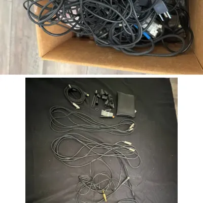 Box filled with various tangled electronic cables and power adapters, alongside a neatly organized collection of audio and video cables...