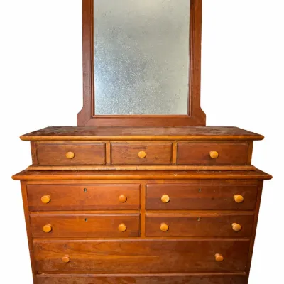 Antique pine or cherry chest of drawers with an attached vanity mirror, featuring a tiered glove box top and wood wooden knobs.