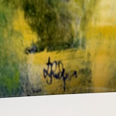 Close-up detail of an artist signature on an impressionistic painting rendered in tones of green and yellow.
