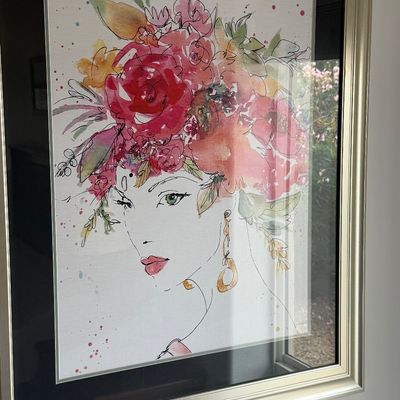 Framed watercolor and ink fashion illustration art print depicting a woman wearing a elaborate floral headpiece.