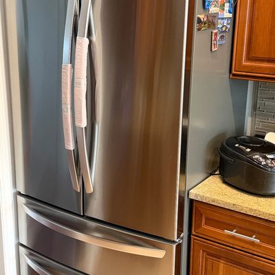 Modern stainless steel LG French door refrigerator with two bottom freezer drawers.