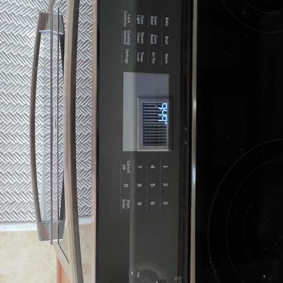 Modern Frigidaire electric range featuring a smooth glass cooktop and a digital control panel.