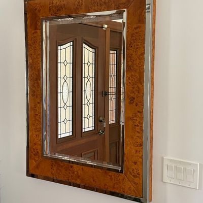 Large rectangular wall mirror featuring a burled wood inlay and polished chrome border trim, late 20th century.