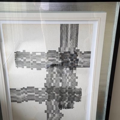 Framed mid-century style black-and-white abstract geometric print, housed in a double-matted silver and black frame.