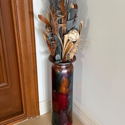 Tall floor vase with a metallic multicolored finish, filled with decorative dried botanicals and twigs.