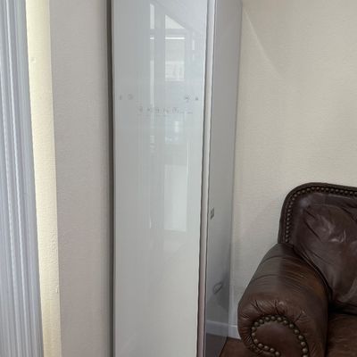 LG Styler modern steam clothing care system in white finish, featuring a high-gloss glass front panel with touch controls.