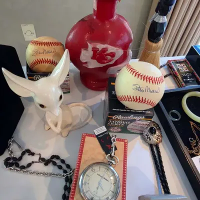 Collection of collectibles including two Stan Musial autographed baseballs in Rawlings boxes, a Kansas City Chiefs red glass decanter, a...
